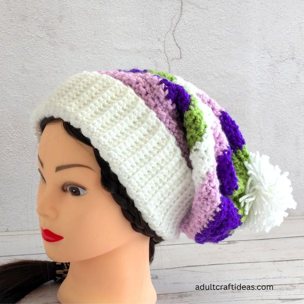 A purple and white crochet beanie.