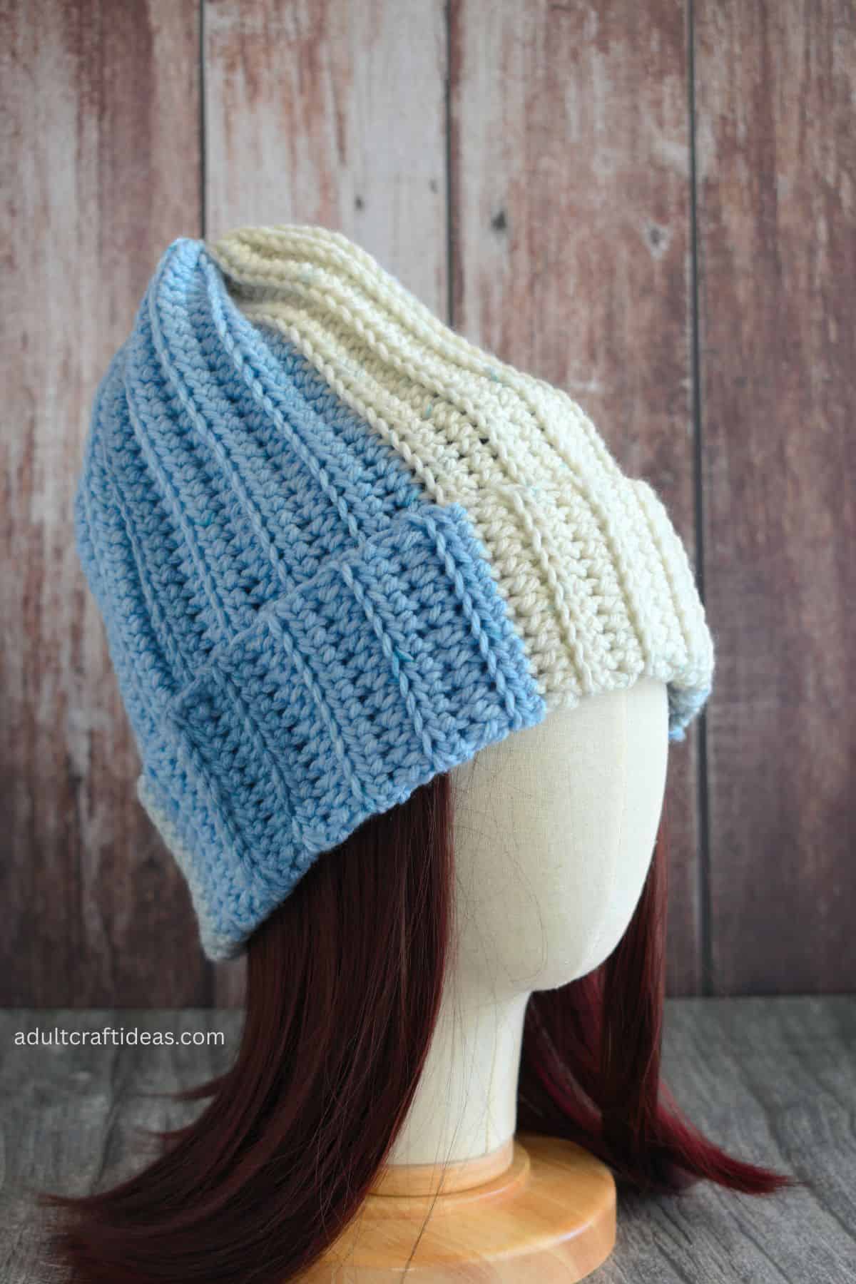 Crochet beanie on a display head.